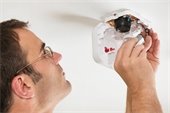 Man Installing Smoke Alarm Battery