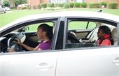 woman driving with children in car