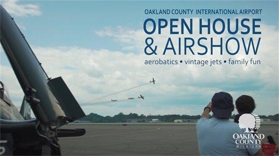 Oakland County air show and open house, planes, man with child